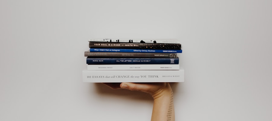 Stack of journals and open notebooks arranged on a wooden table
